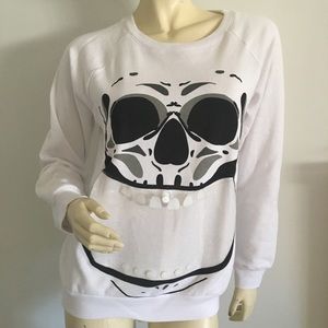 White crewneck Sweatshirt with skull graphic and plastic pouch. Halloween